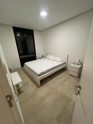 a white bedroom with a bed and a window at Ayla and chill Restricted to families and couples only in Aqaba