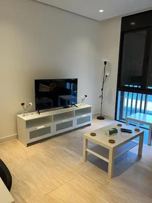 a living room with a large tv and a coffee table at Ayla and chill Restricted to families and couples only in Aqaba