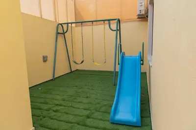 a playground with a blue slide in a room at Adam's Luxury Villa DeadSea in Sowayma