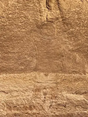 a rock wall with a painting of a guitar on it at Al-Shakriya Village Camp in Wadi Rum