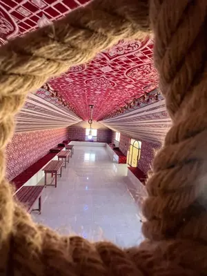 a view of a theatre with red ceilings and chairs at Al-Shakriya Village Camp in Wadi Rum