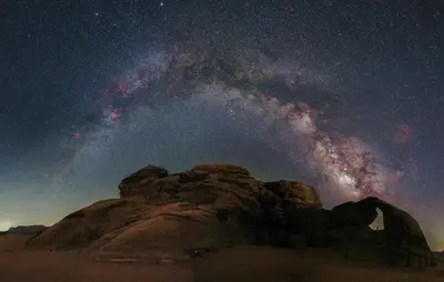 a starry night in the desert with the milky way at Whispering Rum in Wadi Rum