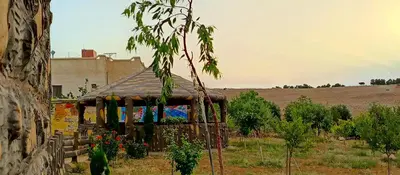 a small house with a roof in a field at Petra Dad Farm (PDF) in Umm Şawwānah