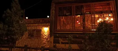 a building with christmas lights on it at night at Petra Dad Farm (PDF) in Umm Şawwānah