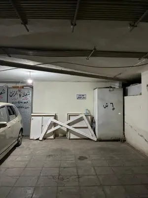 a parking garage with a car parked in it at Furnished Family Apartment in Dahyet Al-Rasheed in Amman