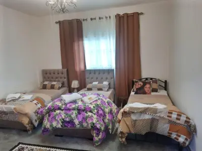 a bedroom with two twin beds and a window at taila hostel in Wadi Musa