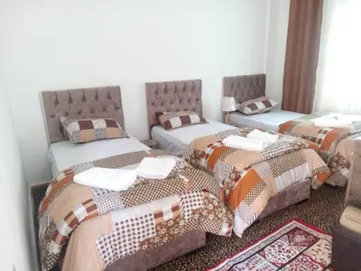 three beds in a room with a room with twothirdsessions at taila hostel in Wadi Musa