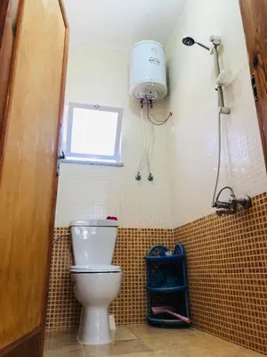a bathroom with a toilet and a window at Pasha's house in Balad al Manşūrah