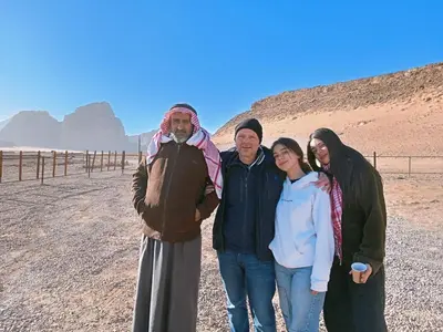 a group of people posing for a picture in the desert at Rayyan Bedouin life camp in Wadi Rum
