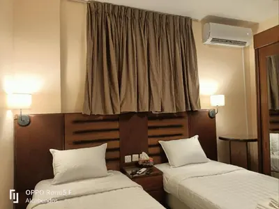 a hotel room with two beds and a window at Plaza de petra in Wadi Musa