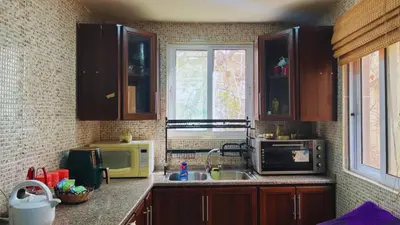 a kitchen with a sink and a microwave at Al Karak House in Kerak