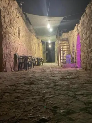 an empty room with chairs and a staircase in a building at Dana Sunset Village Hotel in Dana