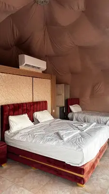 a bedroom with a large bed in a tent at Hakon Matata Wadi Rum Jeep Tours Camp in Wadi Rum