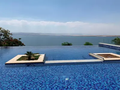 a large swimming pool with a view of the water at Samarah Dead Sea Resort Apartment with Sea View FP4 Traveler Award 2025 Winner Thursday, Friday & Saturday Groups consisting solely of male guests are not permitted in Sowayma