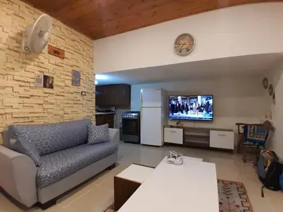 a living room with a couch and a flat screen tv at MK2 - One Bedroom Apartment in Amman