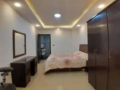 a bedroom with a bed and a sink and a mirror at MK2 - One Bedroom Apartment in Amman