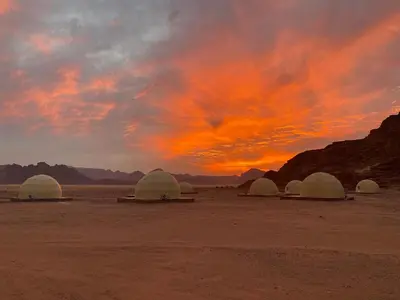 a group of domes in the desert at sunset at Wadi Rum The ARC camp in Wadi Rum
