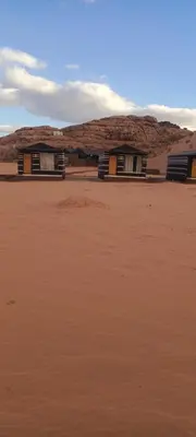 a row of houses in the middle of a desert at Wadi Rum Calma camp in Aqaba