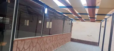 an empty building with glass windows and a ceiling at Wadi Rum Calma camp in Aqaba