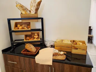 a counter with different types of bread on it at Petra Icon Hotel in Wadi Musa