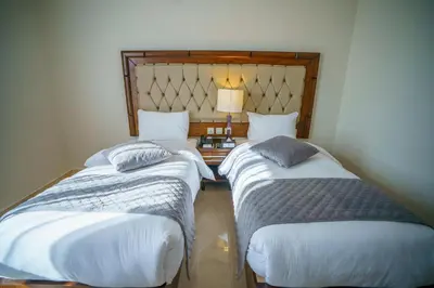 two beds sitting next to each other in a room at Petra Icon Hotel in Wadi Musa