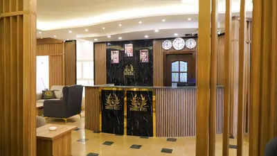 a lobby with a desk and a chair in a room at Sorate Hotel Apartment in Amman