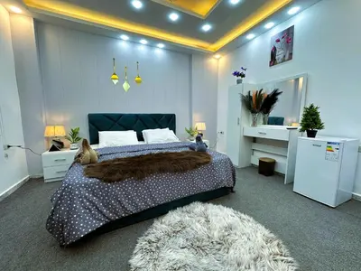 a bedroom with a large bed and a rug at Jerash City View in Jerash