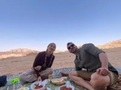 two people sitting at a picnic on the beach at Wadi Rum Gulf camp in Aqaba