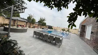a patio with a swimming pool and chairs at Taj Villa 1 deadsea - Entire Villa with sea view in Sowayma