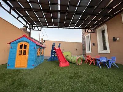 a backyard with a playground with a play set at Taj Villa 1 deadsea - Entire Villa with sea view in Sowayma