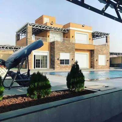 a house with a swimming pool in front of a building at Taj Villa 1 deadsea - Entire Villa with sea view in Sowayma