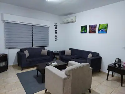 a living room with couches and a couch and a table at Cozy Home 4 in Amman