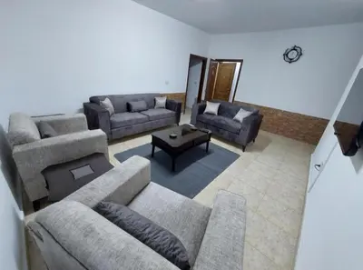 a living room with two couches and a coffee table at Cozy Home 4 in Amman