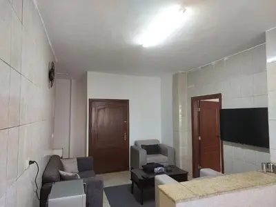 a living room with a couch and a tv at Cozy Home 4 in Amman