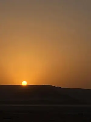 a sunset on a hill in the desert at Bedouin Secret Camp in Wadi Rum