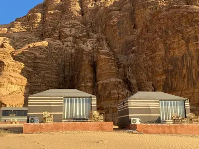 two mobile homes in front of a mountain at Bedouin Secret Camp in Wadi Rum