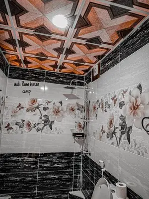 a bathroom with a toilet and flowers on the ceiling at wadi Rum bissan camp in Wadi Rum