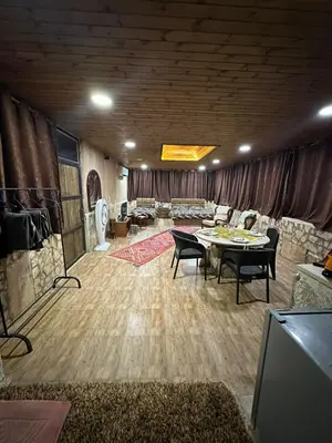a large living room with a table and chairs at Sunset Roof apartment in Madaba