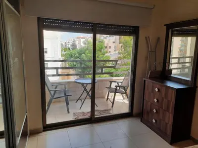 a room with a sliding glass door with a balcony at Furnished apartment for rent In Abdoun شقة مفروشة للايجار في عبدون in Amman