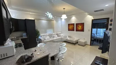 a living room with a couch and a table at Furnished apartment for rent In Abdoun شقة مفروشة للايجار في عبدون in Amman