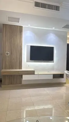 a living room with a television on a wall at Furnished apartment for rent In Abdoun شقة مفروشة للايجار في عبدون in Amman