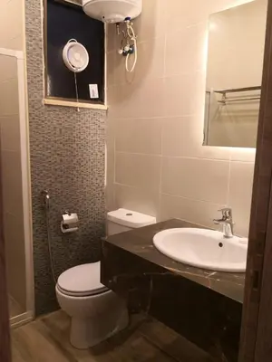 a bathroom with a sink and a toilet and a mirror at Castle beach hotel in Aqaba