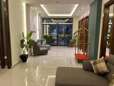 a lobby with a couch and chairs in a building at Sky Hotel in Aqaba