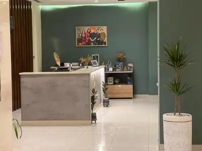 an office lobby with a reception desk and potted plants at Sky Hotel in Aqaba