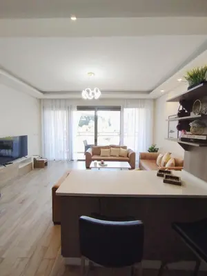 a living room with a couch and a table at Bridge apartments in Amman